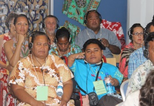 Picture of representatives from Fusi Alofa Association (Tuvalu), Te Toa Matoa (Kiribati) and from Nauru DPA at a conference wearing headphones to listen to the translation of a speech.